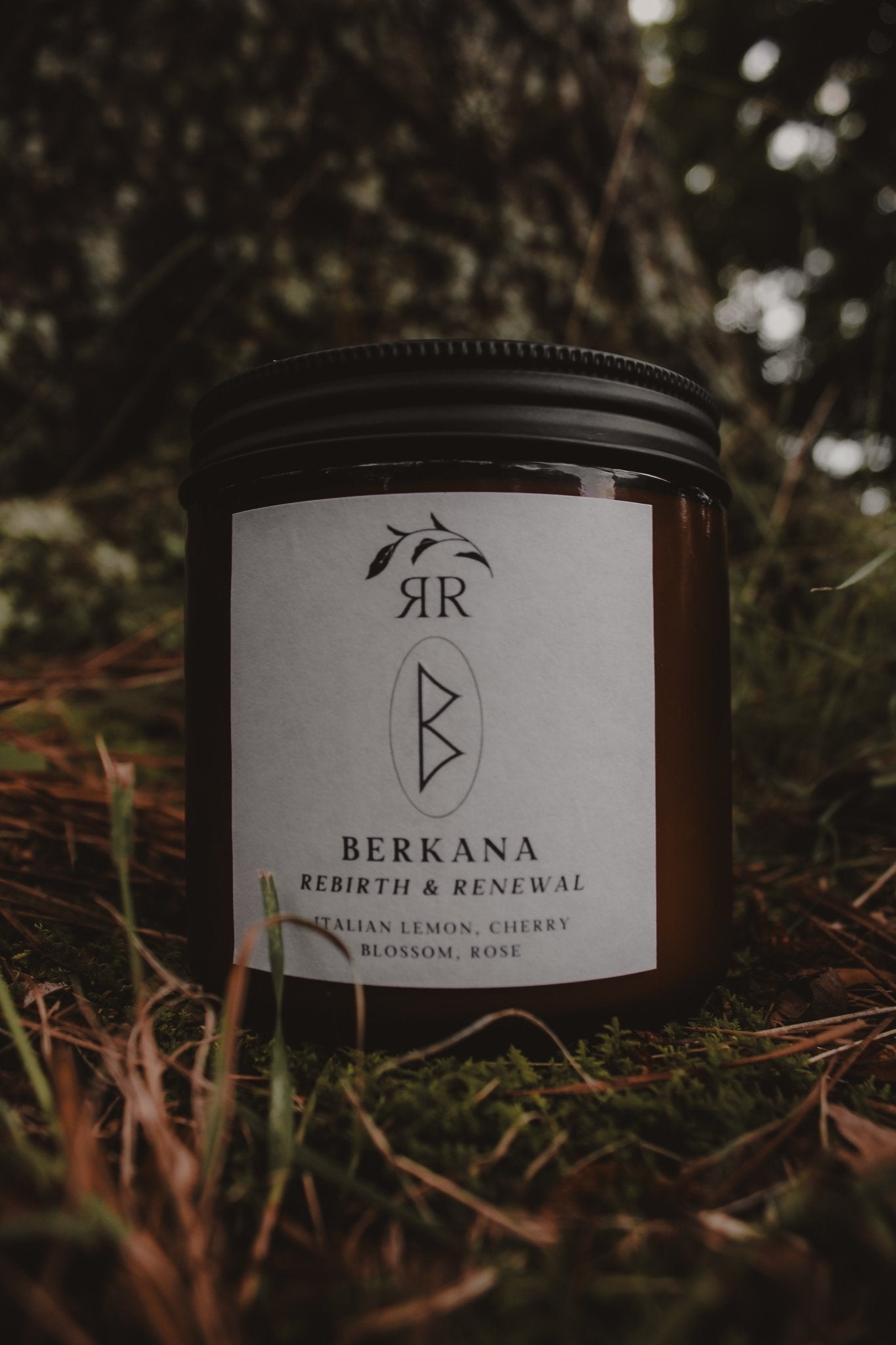 Berkana Rune Candle with lemon, cherry blossom, and rose scents. Glass jar with crackling wooden wick.