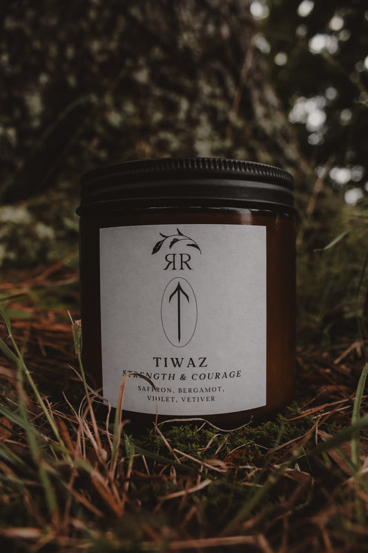 Tiwaz Rune Candle, sophisticated saffron, bergamot, violet, and vetiver scent. Glass jar with crackling wooden wick.